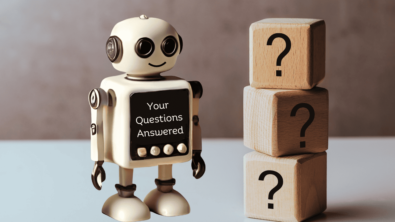 Toy robot with a chalkboard labeled 'Your Questions Answered' next to wooden blocks with question marks.