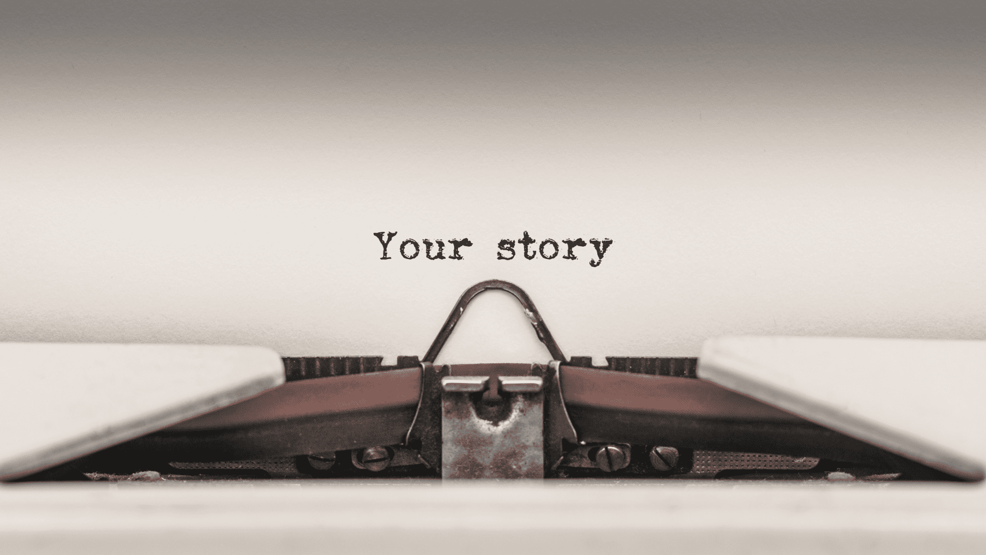 Vintage typewriter with 'Your story' text on a plain background